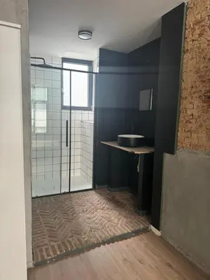 a bathroom with a sink and a glass shower at Мини студия in Antwerp
