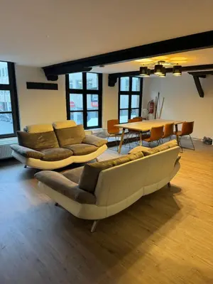 a living room with two couches and a table at Мини студия in Antwerp
