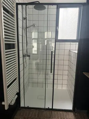 a shower with a glass door in a bathroom at Мини студия in Antwerp