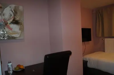 a room with a bed and a table with fruit on it at EU Guesthouse in Brussels