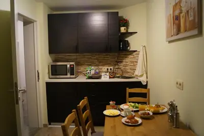 a kitchen with a table with food on it at EU Guesthouse in Brussels