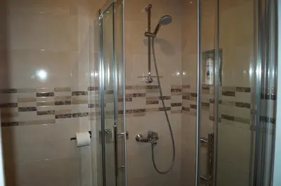 a bathroom with a shower with a glass door at EU Guesthouse in Brussels