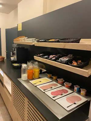 a buffet line with plates of food and drinks at Hotel Cleo in Kasterlee