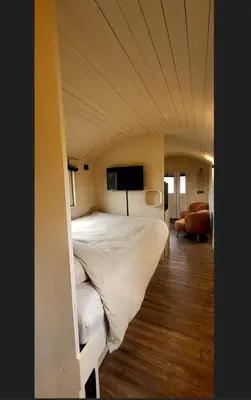 a large bed in a room with a tv at BelleLiv in Nijlen