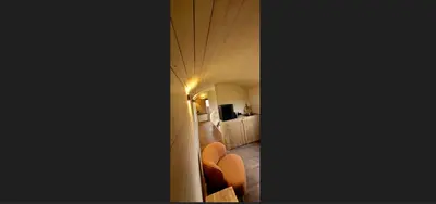 a corridor of a hotel room with orange chairs at BelleLiv in Nijlen