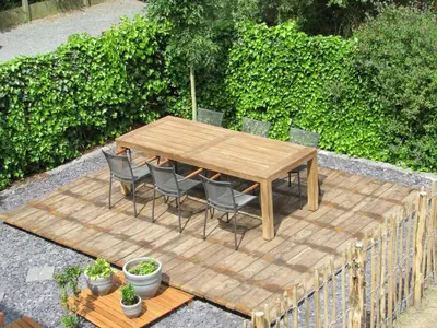 a wooden table and chairs sitting on a patio at B&B Wiezebed in Wieze
