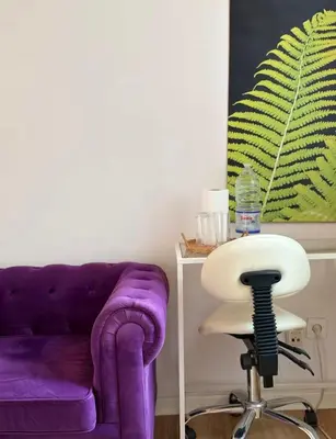 a purple couch and a chair in a room at Purple Sofa in Antwerp
