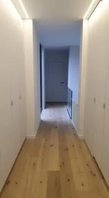 an empty hallway with a wooden floor and a door at Tomorrowland2026 Basecamp in Mechelen