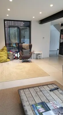 a living room with a chair and a table at Tomorrowland2026 Basecamp in Mechelen