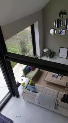 a living room with a couch and a large window at Tomorrowland2026 Basecamp in Mechelen