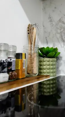a shelf with jars of food and a plant on it at Charmant Studio - Centre-ville - 2min de Métro - 401 in Brussels