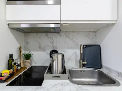 a kitchen counter with a sink and a mixer at Charmant Studio - Centre-ville - 2min de Métro - 401 in Brussels