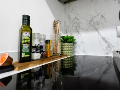 a counter with a bottle of wine on a shelf at Charmant Studio - Centre-ville - 2min de Métro - 401 in Brussels