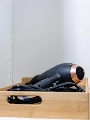 a black object sitting on top of a wooden table at Charmant Studio - Centre-ville - 2min de Métro - 401 in Brussels
