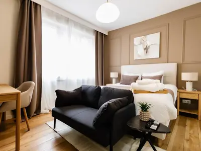 a living room with a couch and a bed at Cozy Studio - Downtown - 2 min from Metro - 201 in Brussels