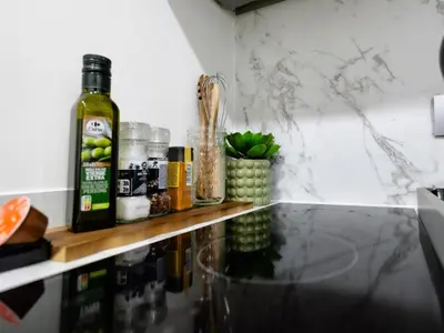 a counter with a bottle of wine on a shelf at Cozy Studio - Downtown - 2 min from Metro - 201 in Brussels