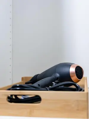 a blow dryer sitting on top of a wooden table at Cozy Studio - Downtown - 2 min from Metro - 201 in Brussels