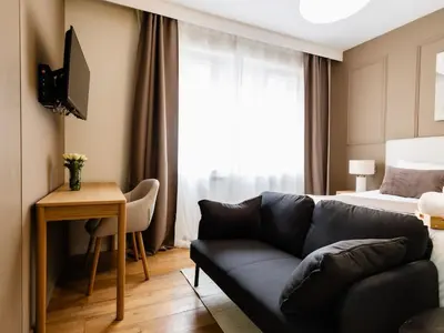 a living room with a couch and a bed at Cozy Studio - Downtown - 2 min from Metro - 201 in Brussels