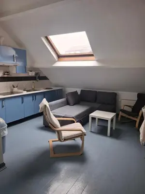 a living room with a couch and a skylight at Central Stay in Brussels