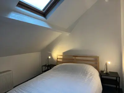 a bedroom with a white bed with two night stands at Central Stay in Brussels