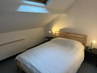 a bedroom with a white bed and two night stands at Central Stay in Brussels