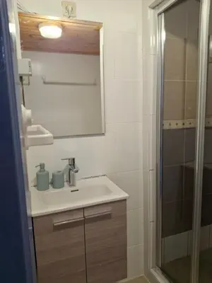 a bathroom with a sink and a shower at Central Stay in Brussels