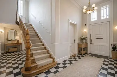 a staircase in a hallway with a checkered floor at Luxury villa with pool for 14 people in Essen
