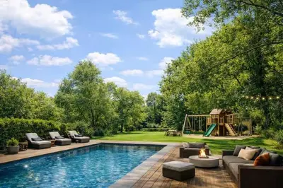 a backyard with a swimming pool and a playground at Luxury villa with pool for 14 people in Essen