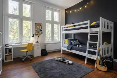 a bedroom with two bunk beds and a desk at Luxury villa with pool for 14 people in Essen
