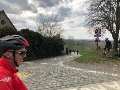 a man in a helmet standing on a stone road at The BEE Garden in Lede