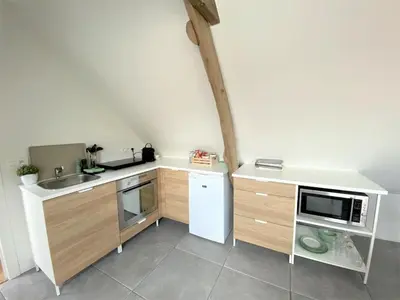 a small kitchen with a sink and a microwave at The BEE Garden in Lede