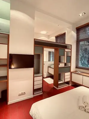 a bedroom with a bed and a tv in it at Loft a stone's throw from Place Brugmann in Brussels