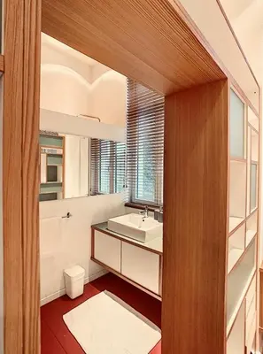 a bathroom with a sink and a toilet and a mirror at Loft a stone's throw from Place Brugmann in Brussels