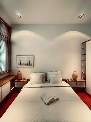 a bedroom with a large white bed with white pillows at Loft a stone's throw from Place Brugmann in Brussels