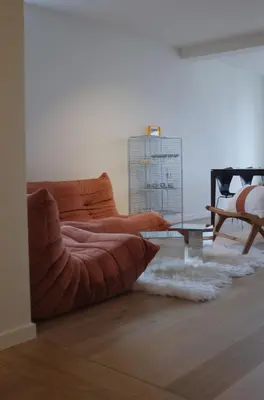 a living room with a couch and a table at Design appartement met zonnig terras bij Gravensteen in Ghent