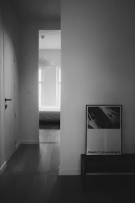 a living room with a tv on a white wall at Design appartement met zonnig terras bij Gravensteen in Ghent