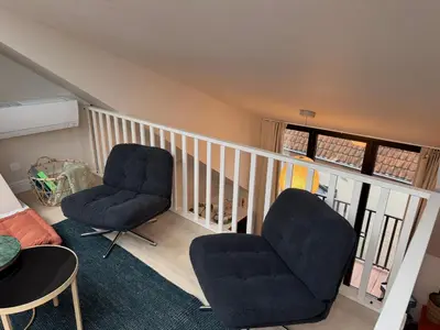 two chairs and a table in a living room at Kaffee Changé in Ghent