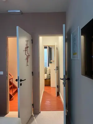 a hallway with two open doors and a living room at Kaffee Changé in Ghent