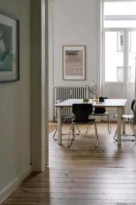 a living room with a table and chairs and a window at A Place Antwerp - Boutique Suites & Flats - Schuttershofstraat 1 in Antwerp