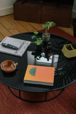 a table with a book and a computer mouse and a keyboard at A Place Antwerp - Boutique Suites & Flats - Schuttershofstraat 1 in Antwerp