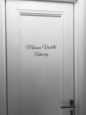 a white door with a sign that reads master variable gallery at Maison Violette Antwerp in Antwerp