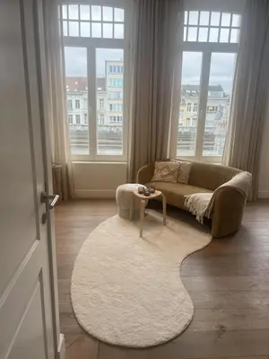 a living room with a couch and a table at Maison Violette Antwerp in Antwerp