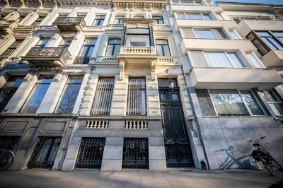 a building with a bunch of windows on it at Master Suite Le Monarque Antwerp in Antwerp