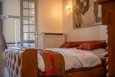 a bedroom with a bed and a window at Master Suite Le Monarque Antwerp in Antwerp