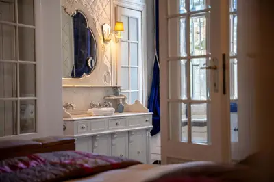 a bathroom with a sink and a mirror at Master Suite Le Monarque Antwerp in Antwerp