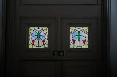 a pair of stained glass windows on a door at Master Suite Le Monarque Antwerp in Antwerp