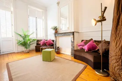 a living room with a couch and a fireplace at Le Machaon Antwerp Suite in Antwerp