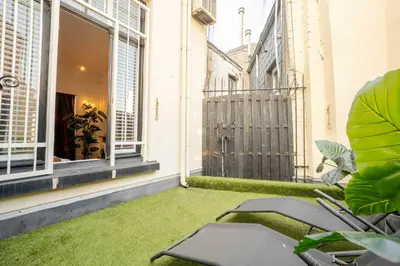 a balcony with green grass and chairs on a building at Le Machaon Antwerp Suite in Antwerp