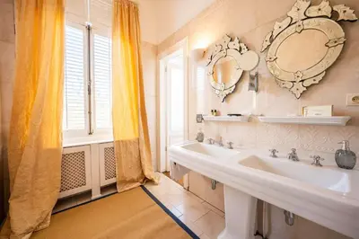 a bathroom with a sink and a mirror on the wall at Le Machaon Antwerp Suite in Antwerp