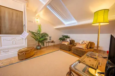 a living room with a couch and a table at Le Nymphale Suite Antwerp in Antwerp